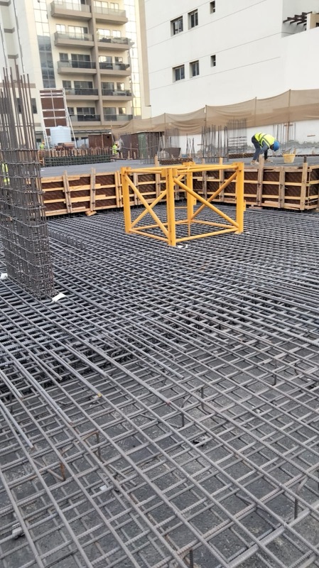 Raft reinforcement mat with timber formwork panels and a yellow steel frame