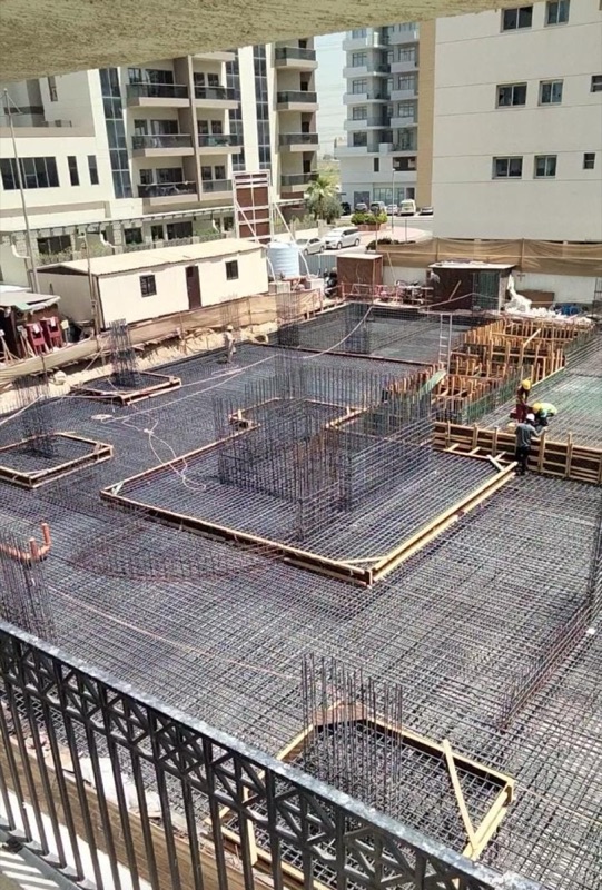 Overhead view of a raft foundation with reinforcement mats, lift-pit cages and timber edge formwork